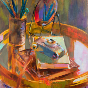 Still life painting with a mirror, books, vintage camera and brushes