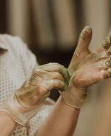 A woman putting on gloves for painting