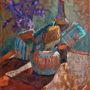 Still life painting with brushes, purple flowers and a glass bottle