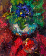 Blue Viola flowers and a ripe apple gracefully arranged on a striking red backdrop